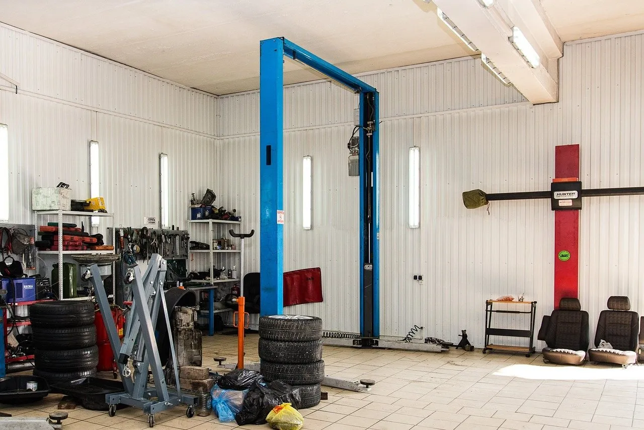 Repair shop with a two-post car lift, tires and tool cabinets