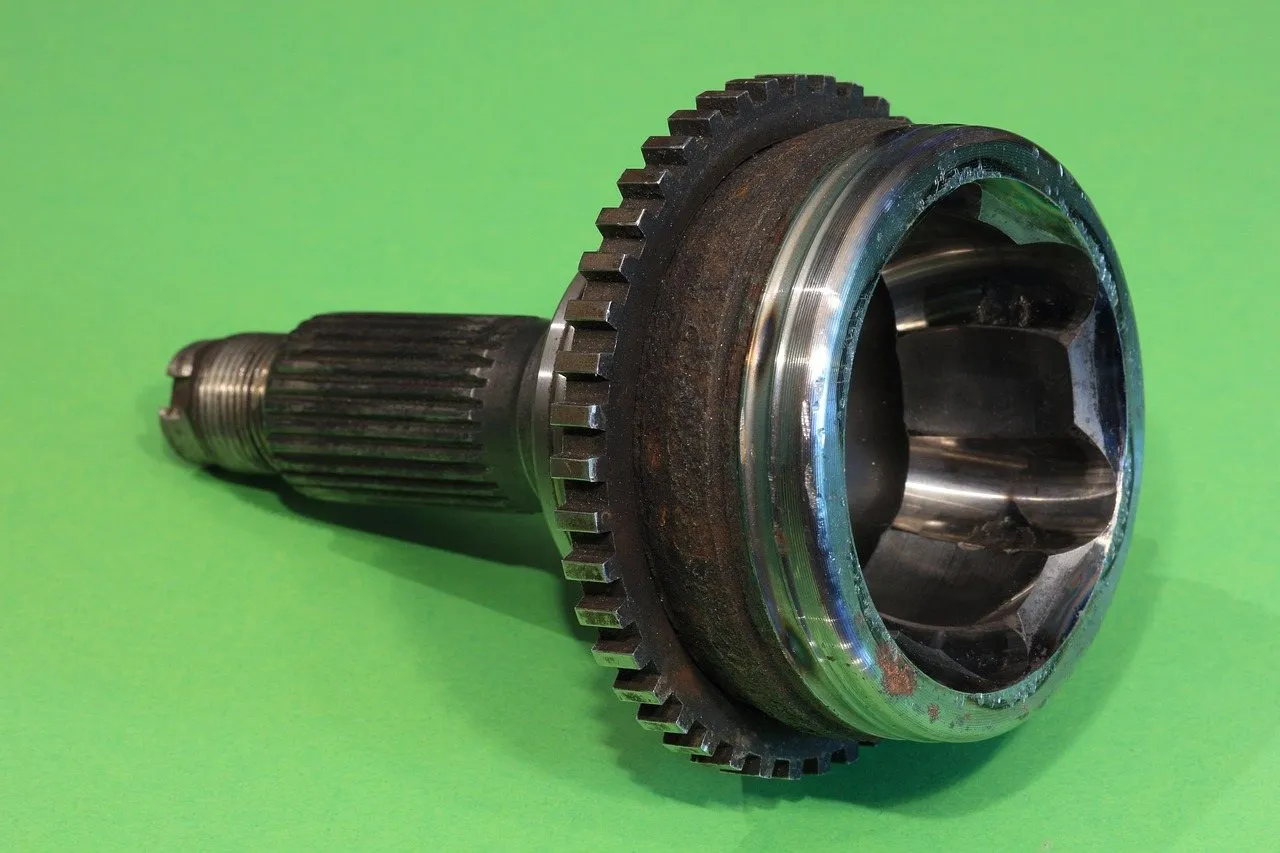 Close-up of a CV joint and axle shaft from a car's drivetrain