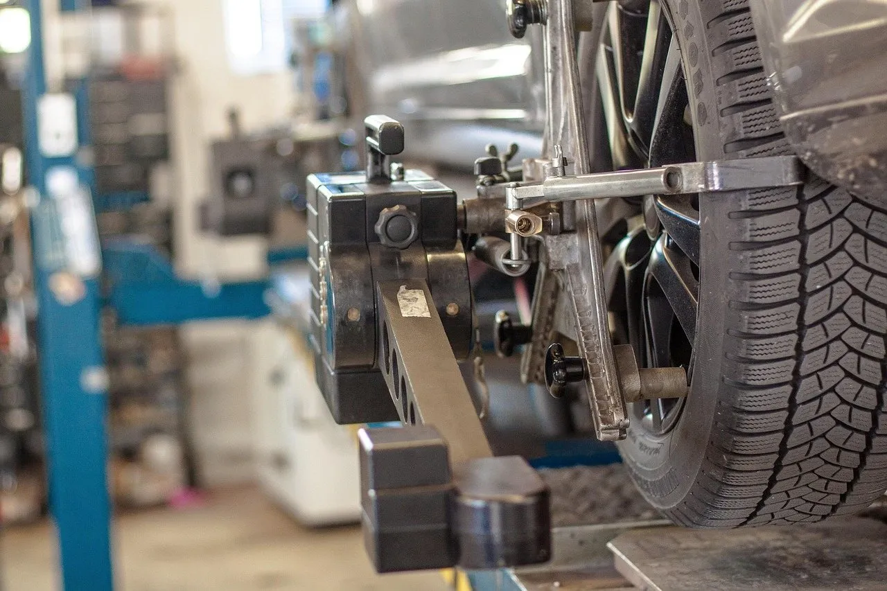 Car on a workshop lift with the wheel hub and axle area exposed