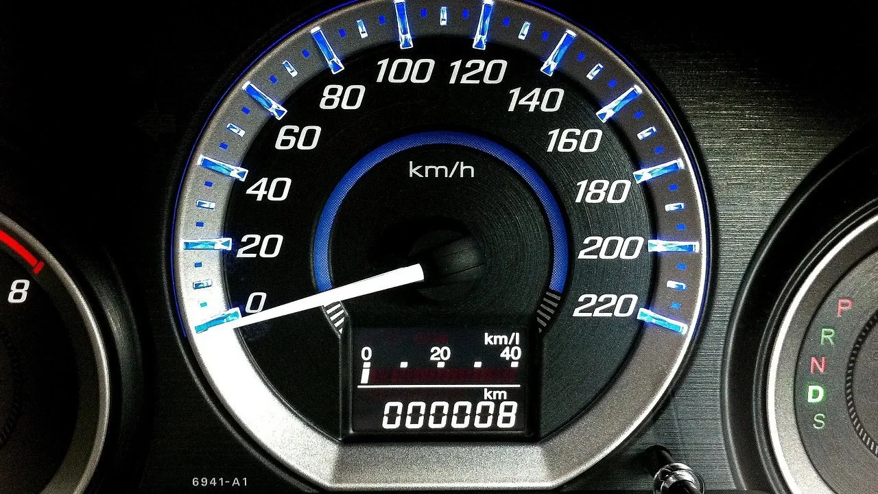 Car instrument cluster with the odometer showing almost zero miles on a new vehicle