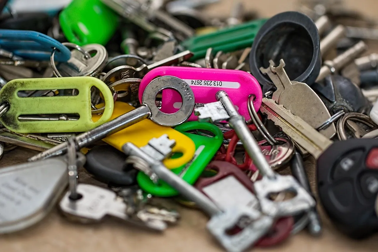 A pile of car keys on a flat surface
